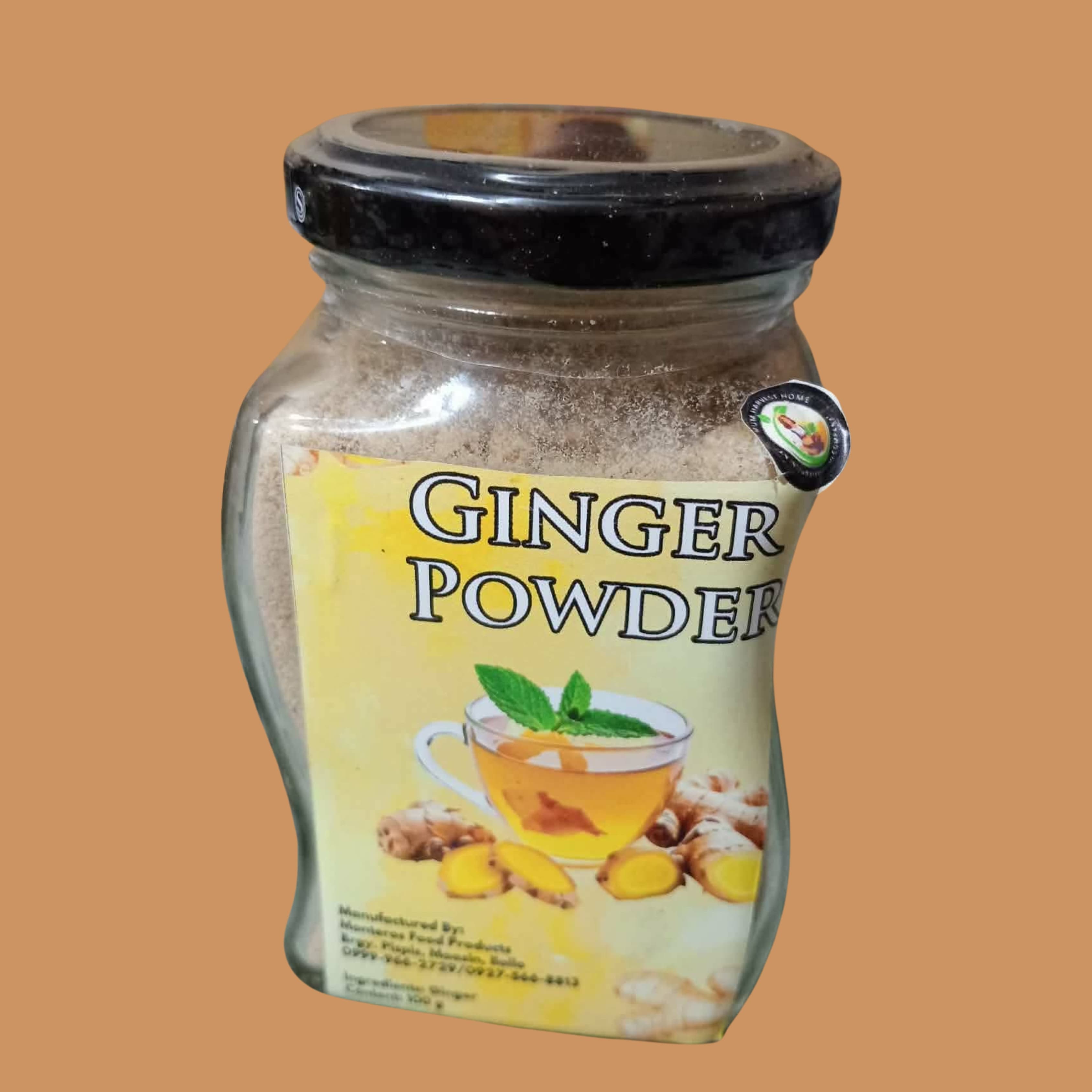 Artisanal packaging of organic Ginger Powder with fresh knobby ginger roots on a rustic wooden surface